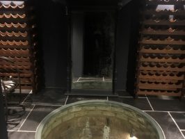 Glass well cover in a refurbished cellar.